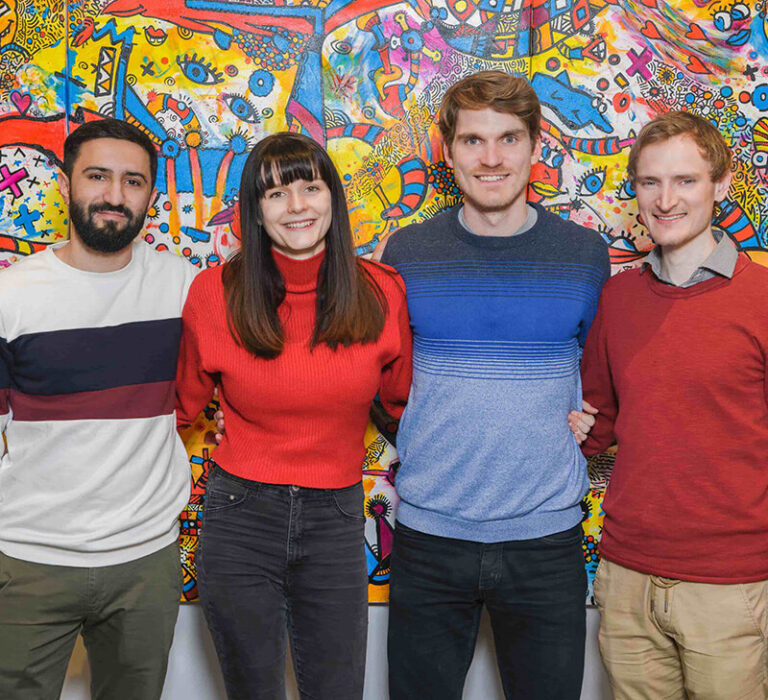 4 young persons smiling